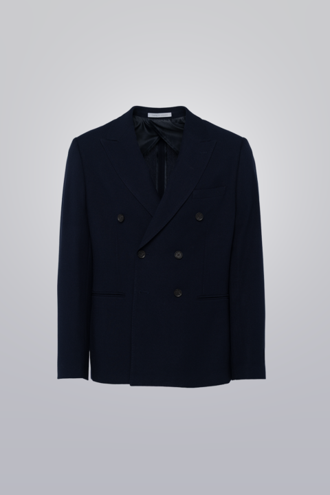 Double breasted blazer in navy made from TR poly viscose fabric. Features peak lapel, six buttons, and pipped pockets. Unconstructed for comfort.