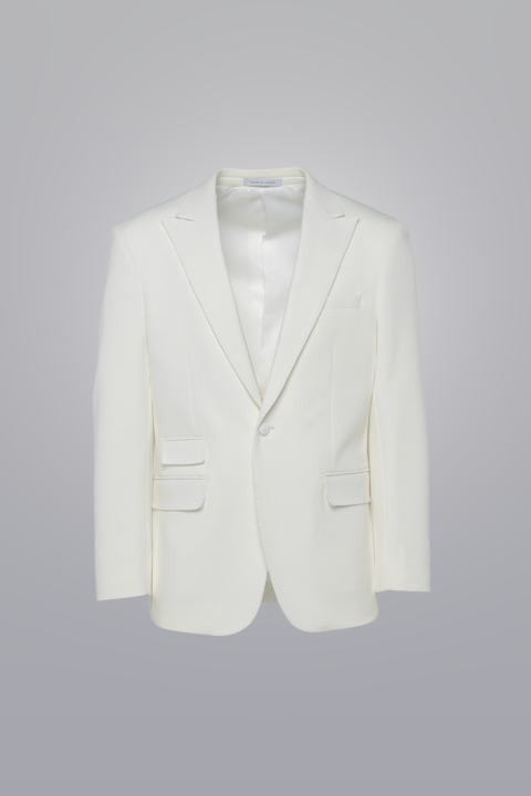 Pique Coat - White made with TR poly viscose fabric. Textured, single-breasted coat with peak lapel, three flap pockets, and fabric-covered button.