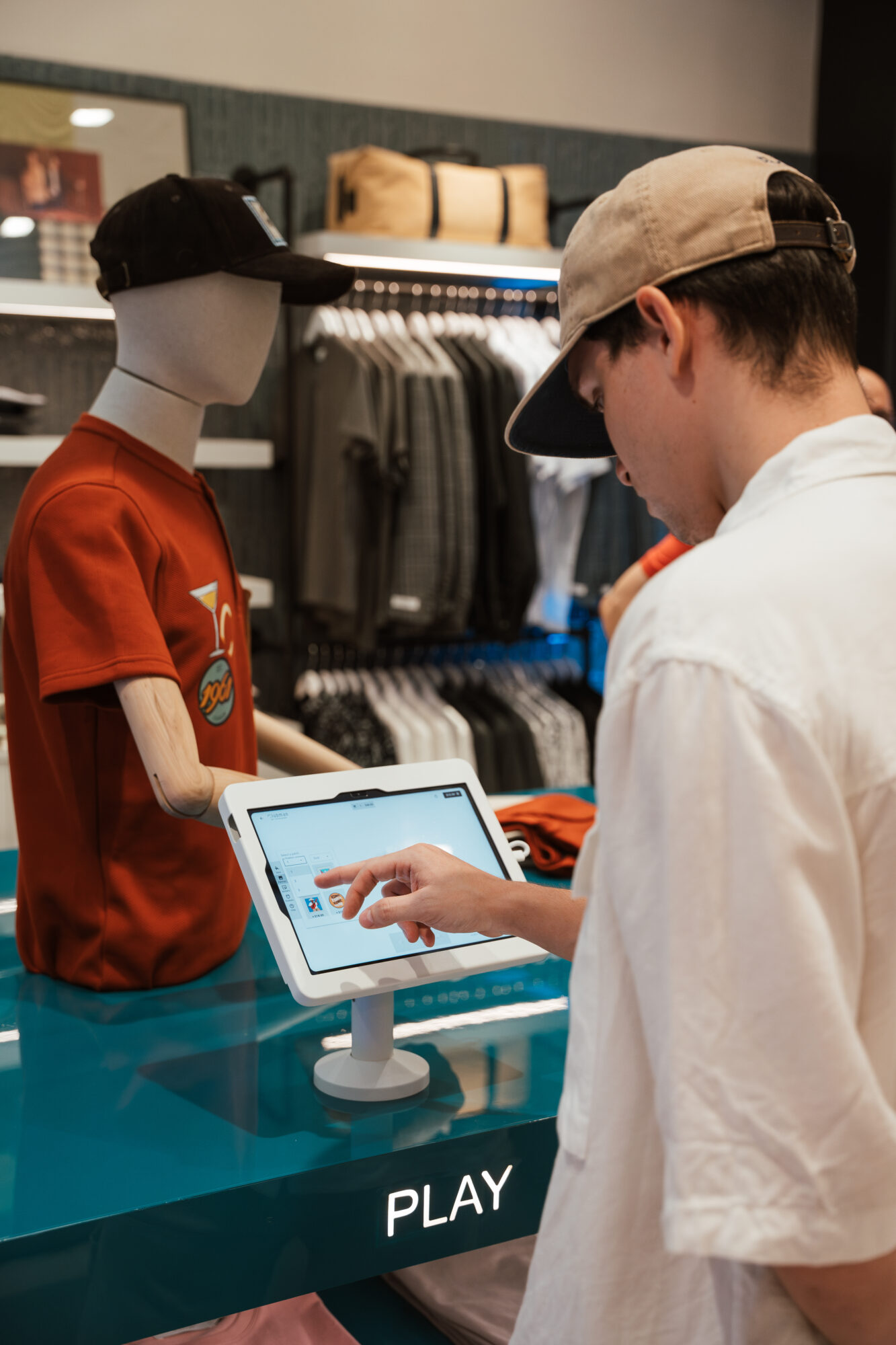 Person interacting with a digital display in Clubman by Leonardo, Plaza las Americas