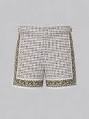 Green silk swim short for men featuring an all-over geometric print, adjustable side straps, button and zipper closure, metal hardware, zippered back pockets, and mesh lining by Clubman by Leonardo.