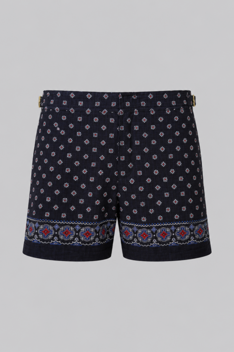 Navy silk swim short for men featuring an all-over geometric print, adjustable side straps, button and zipper closure, metal hardware, zippered back pockets, and mesh lining by Clubman by Leonardo.